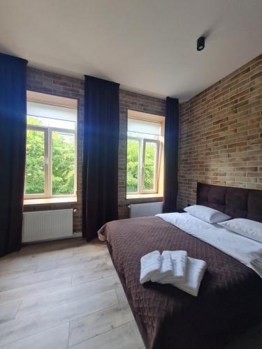 a bedroom with a large bed with two towels on it at Апартаменти в центрі по вул Л Українки,46 in Luts'k