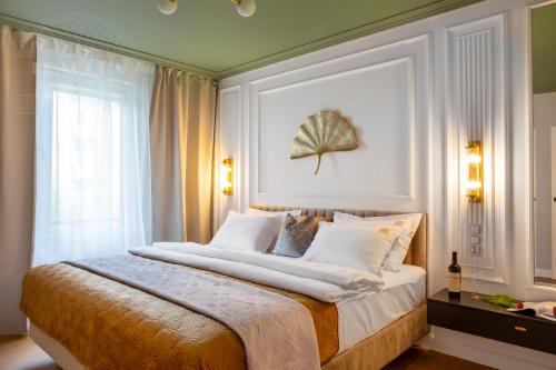 a bedroom with a large bed with a large window at Fragola Apartments Old Town in Kraków