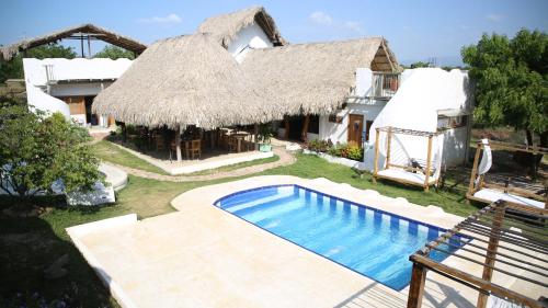 an image of a house with a swimming pool at Casa Dibulla Hotel Boutique in Dibulla