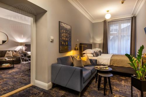 a hotel room with a bed and a couch at Fragola Apartments Old Town in Kraków