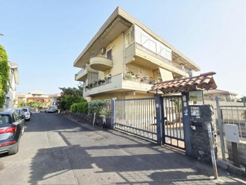 a house with a gate and a fence at Sicily Sea Home in Aci Castello