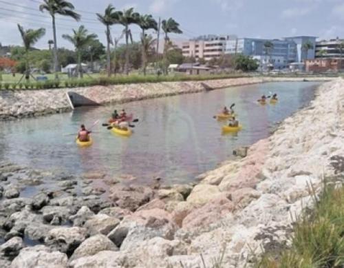 a group of people in kayaks in a river at Tropical Apartment with private patio, Walk to Beaches, Shops and Cafes in Saint Peter