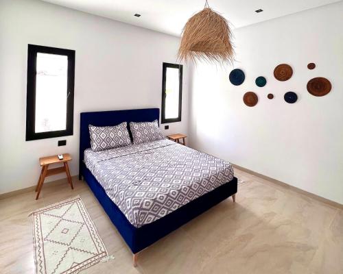 a bedroom with a blue bed in a room at Villa Ubud Hammamet in Hammamet Sud