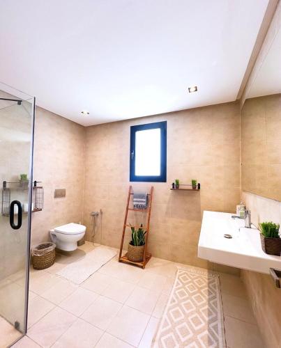 a bathroom with a toilet and a sink and a shower at Villa Ubud Hammamet in Hammamet Sud