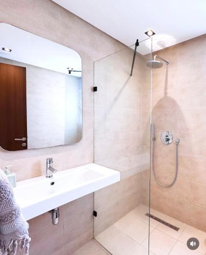a bathroom with a sink and a shower at Villa Ubud Hammamet in Hammamet Sud
