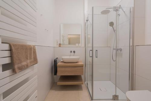 a bathroom with a sink and a glass shower at Wave1 in Norderney