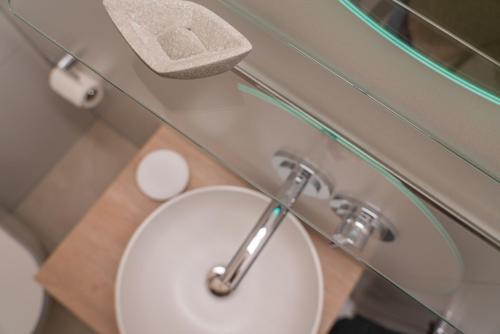 a bathroom with a white toilet with a glass wall at Wave1 in Norderney