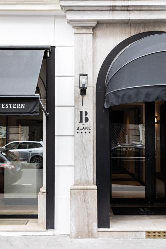 a store front with two windows and an awning at Best Western Premier The Blake Paris Gare Saint Lazare in Paris