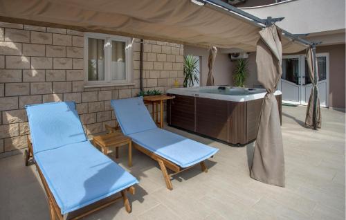 a patio with two chairs and a bath tub at Awesome Home In Imotski in Imotski