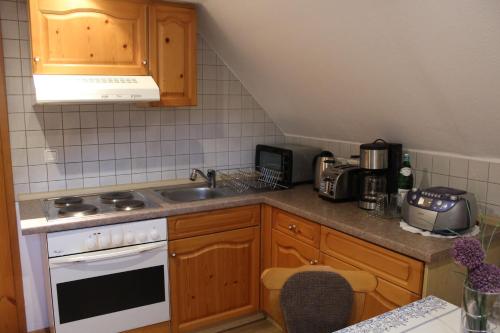 a kitchen with a sink and a stove top oven at Ferienwohnung Landidylle in Birx