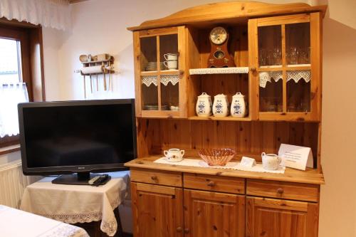 a large wooden hutch with a tv and a tvicterictericter at Ferienwohnung Landidylle in Birx