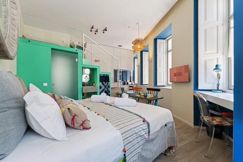 a bedroom with a large bed with a green headboard at GuestReady - AMMA Braga Apartments in Braga