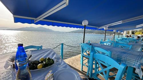 a table with a plate of food on a boat at Evia Bay Suites and Retreats in Edipsos