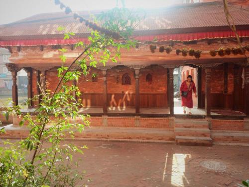 a person standing in the doorway of a building at Swastik Guest House in Bhaktapur