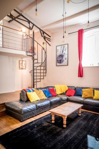 a living room with a leather couch and a coffee table at Gite Belle Vue, Sourdeval in Sourdeval