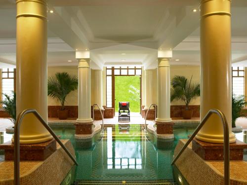 a lobby with a swimming pool with columns and a pool at The Brehon Hotel & Spa in Killarney