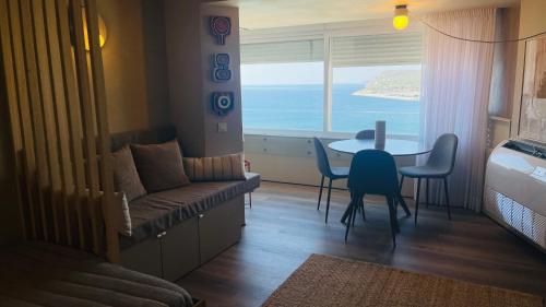 a living room with a couch and a table with a view at 903 by the sea in Sesimbra