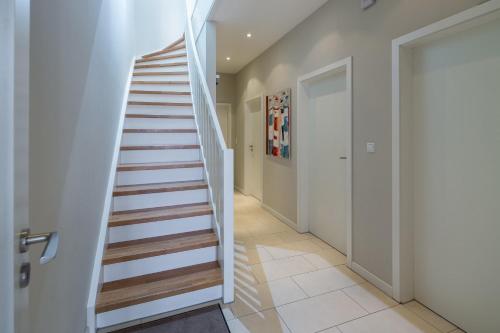 a staircase in a hallway with white walls at Robbenloft in Norderney