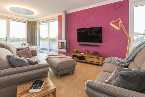 a living room with two couches and a tv at Luxus Spa Penthouse Sundowner in Göhren-Lebbin