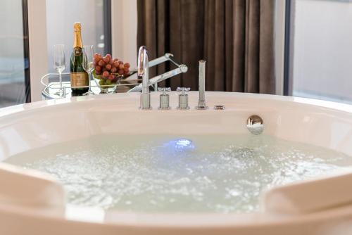 a bath tub filled with lots of water at Luxus Spa Penthouse Sundowner in Göhren-Lebbin