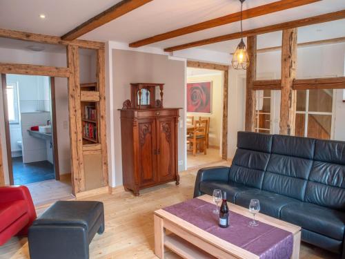 a living room with a couch and a table at Kleine Bergstraße 2 - Haus 1 in Tanne