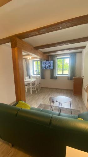 a living room with a couch and a table at Brennerei Federow in Federow