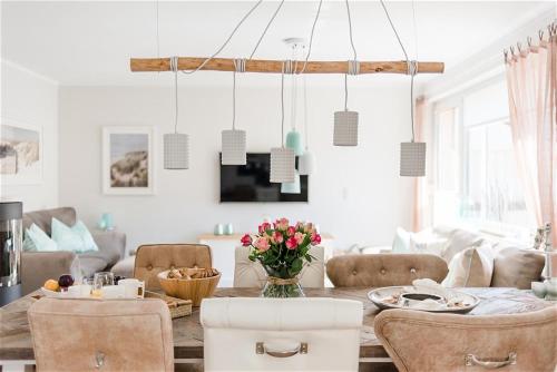 a living room with a dining room table with chairs at Strandlust in Zingst