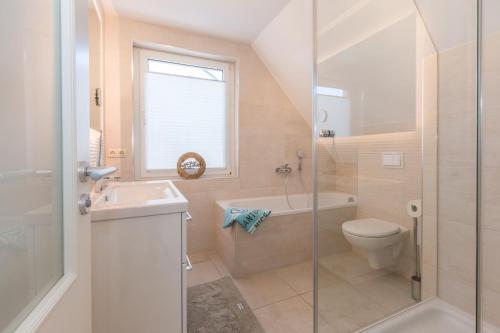 a bathroom with a toilet and a sink and a shower at Strandlust in Zingst