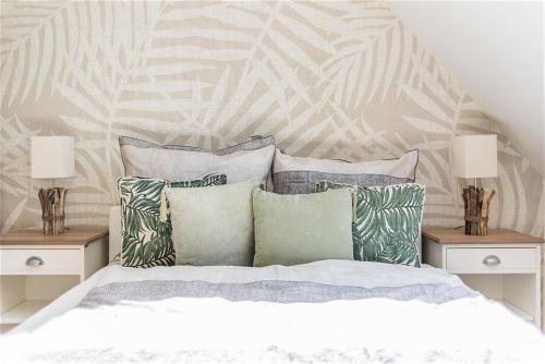 a bedroom with a bed with pillows and two night stands at Strandlust in Zingst