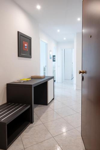 an office with a desk and a bench in a room at Casa Vacanze Panorama in Brunate