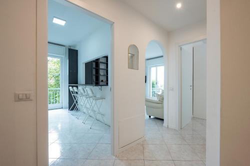 a living room with white walls and a large window at Casa Vacanze Panorama in Brunate