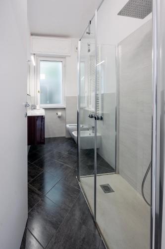 a bathroom with a glass shower and a sink at Casa Vacanze Panorama in Brunate