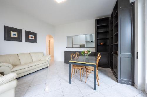 a living room with a table and chairs and a couch at Casa Vacanze Panorama in Brunate