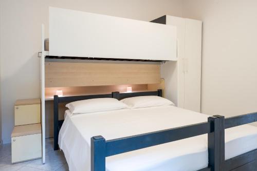 a bedroom with a bunk bed with white sheets at Casa Vacanze Panorama in Brunate