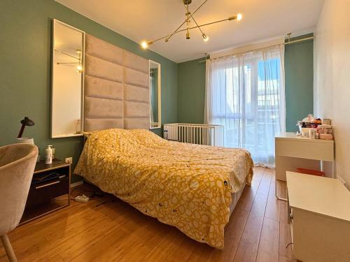 a bedroom with a bed and a desk and a window at Bezons Golden - 3 chambres - 3min du Tramway #SirDest in Bezons