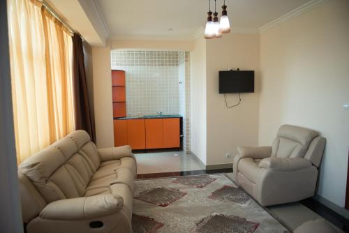 a living room with two chairs and a couch at C Fun Addis Hotel in Addis Ababa