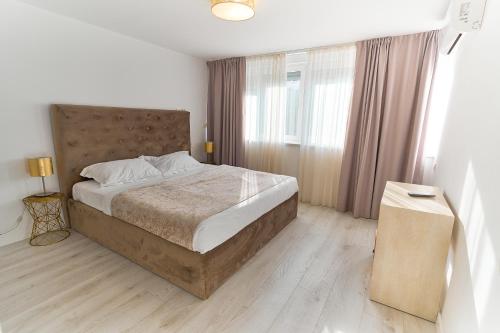 a bedroom with a large bed and a large window at Apartments Lukas 7 in Zadar