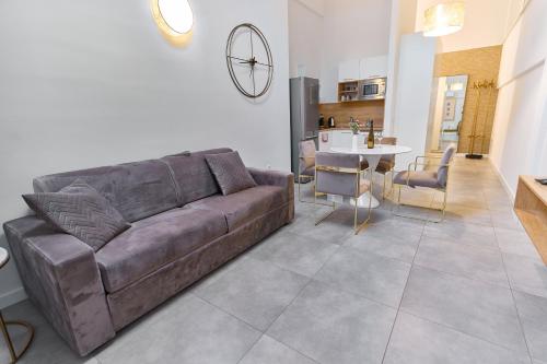 a living room with a brown couch and a table at Apartments Lukas 7 in Zadar