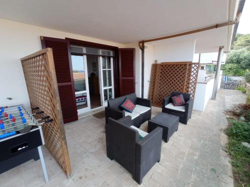 a patio with two chairs and a table at Incantevole suite con veranda in Giglio Porto