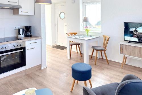 Una cocina y una sala de estar con mesa y sillas. en Ferienwohnung Kamske, en Lübbenau