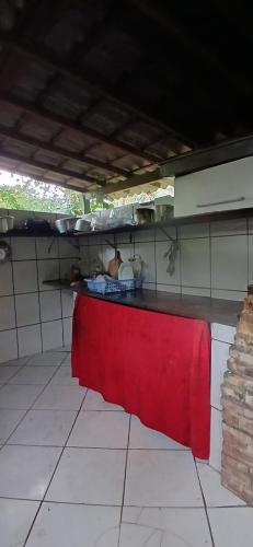 a kitchen with a red table in a room at Camping Refugio SacodoCeu2026 in Saco do Ceu