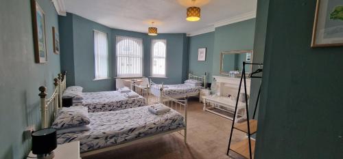 a room with two beds and a mirror at Westward Ho Hotel in Folkestone
