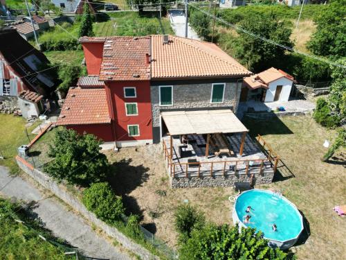 an aerial view of a house with a swimming pool at Villa with panoramic views at Minucciano ! in Magliano