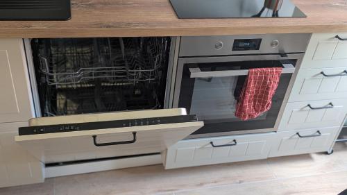 a kitchen with an oven with its door open at Ferienwohnung Wittle in Weiler-Simmerberg