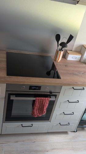 a kitchen with a counter with a stove top oven at Ferienwohnung Wittle in Weiler-Simmerberg