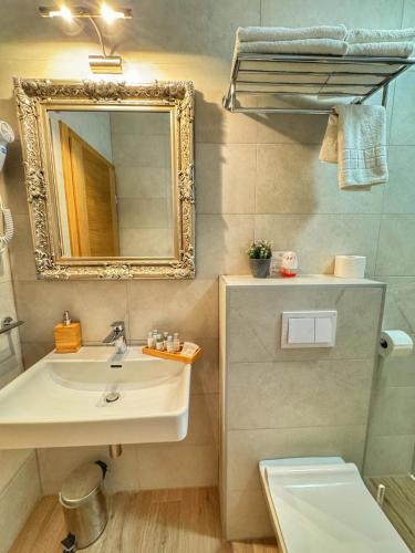 a bathroom with a sink and a mirror at Etno Garden Apartments in Plitvička Jezera