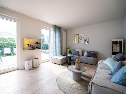 una sala de estar con un sofá y una mesa en Ferienhaus "Das Strandod", en Heringsdorf