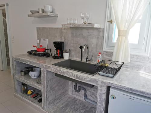 a kitchen with a sink and a counter top at Amorgos Meltemi Apartments in Amorgos