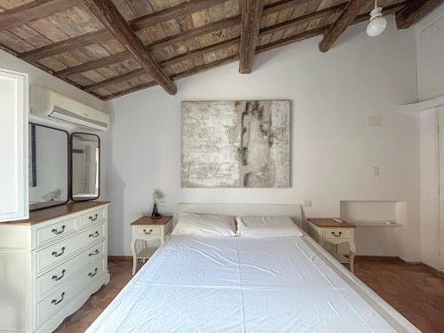 a bedroom with a white bed and a tv at Attic Castel Sant'Angelo - Pantheon in Rome