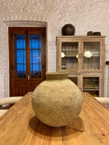 a vase sitting on top of a wooden table at Hotel Quinta Solera in Oviedo